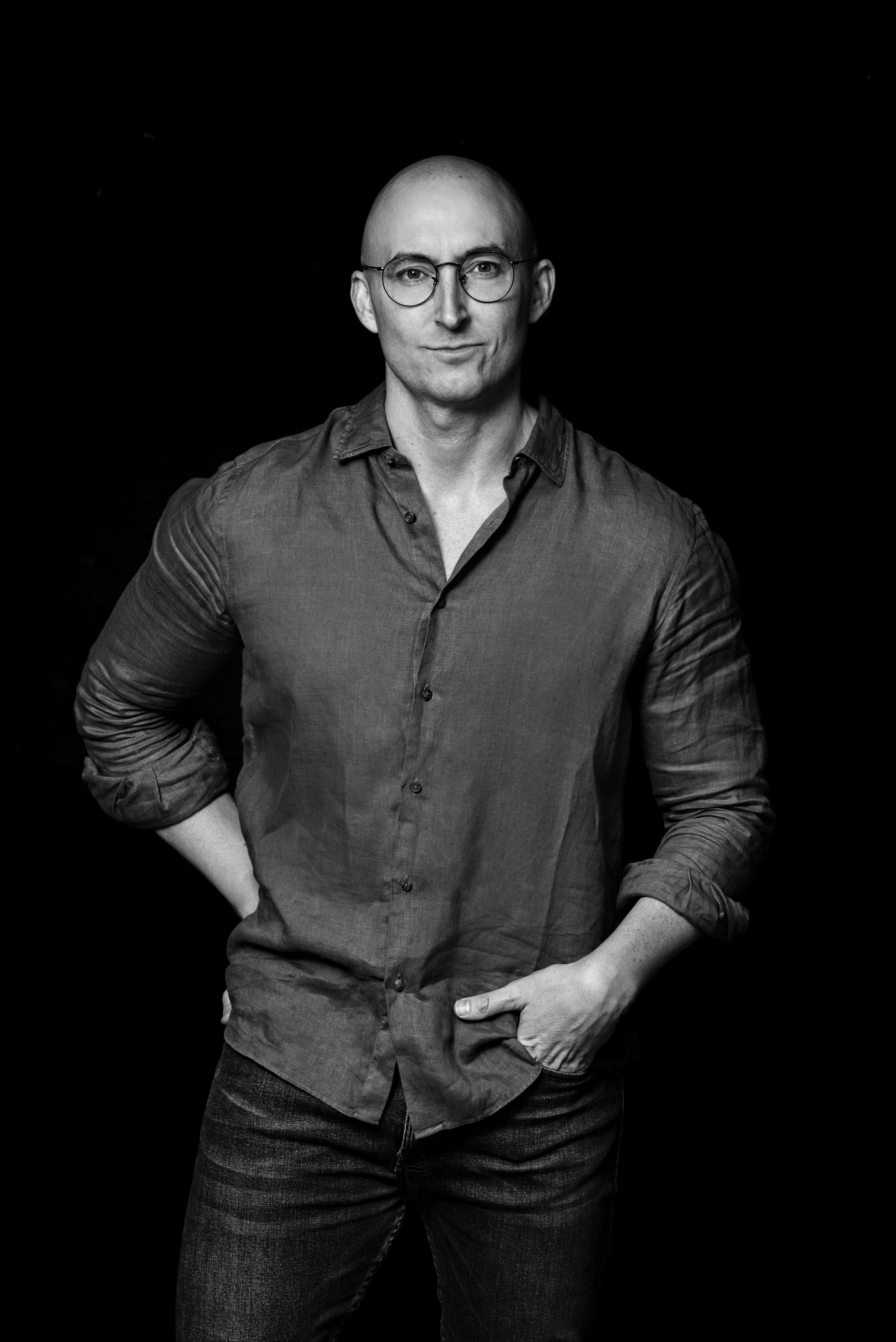 JJ Delgado, black-and-white studio portrait.