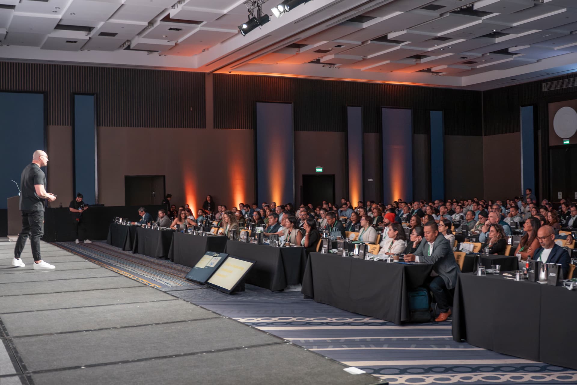 JJ Delgado delivering the Irreplaceable keynote on an international business stage.