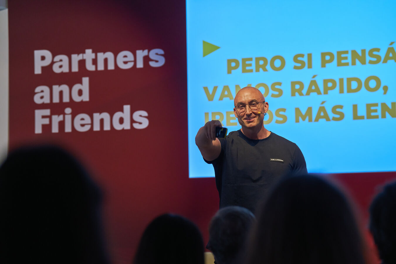 JJ Delgado on stage speaking to an audience about people, data and impact.